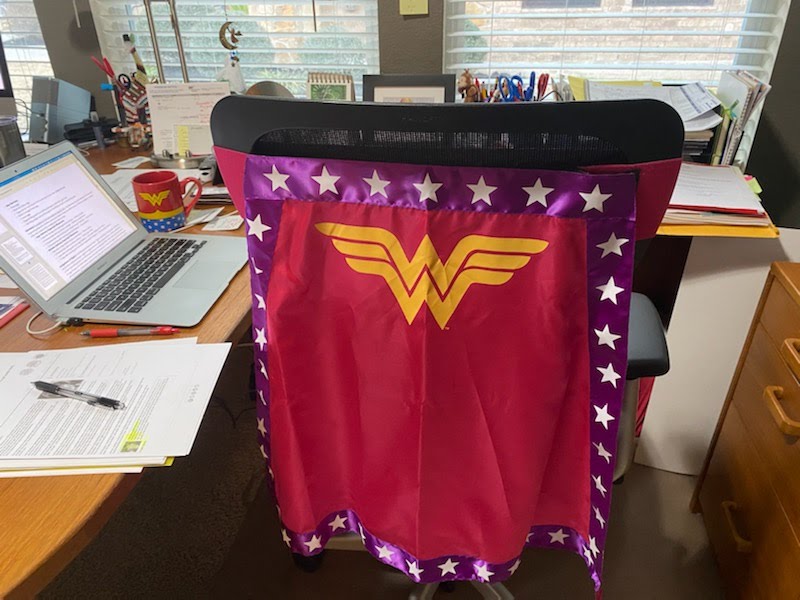 Wonder Woman cape on the back of an office chair at a writing desk